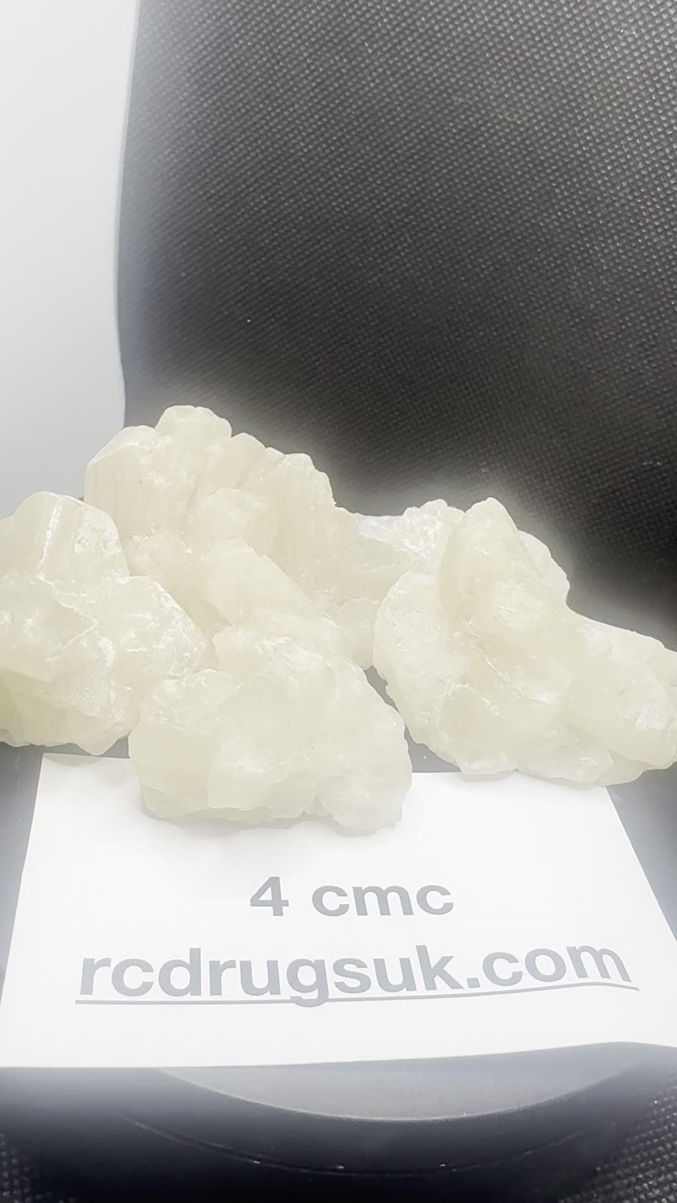 4-CMC crystals with a batch card.